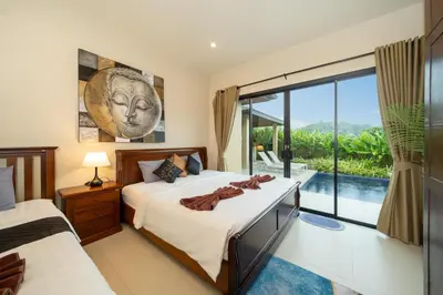 a bedroom with a bed and a large window at Naiharn Beach 4 Bedroom Villa in Nai Harn Beach
