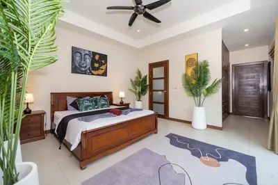 a bedroom with a bed and a ceiling fan at Naiharn Beach 4 Bedroom Villa in Nai Harn Beach