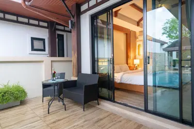 a room with a bed and a table and a bedroom at Rawayana 3 Bedroom Villa in Rawai Beach