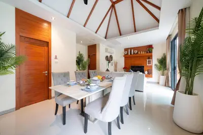 a dining room with a table and chairs at Rawayana 3 Bedroom Villa in Rawai Beach