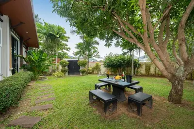 a picnic table and benches in a yard at Rawai Park Big Garden Villa 3D10 in Rawai Beach