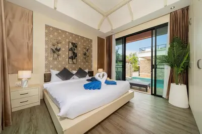 a bedroom with a large bed and a large window at Rawai Park Big Garden Villa 3D10 in Rawai Beach