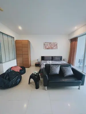 a living room with a bed and a couch at Chic 10 minutes to reach the karon beach, with free swimming pool and gym, WIFI in Karon Beach