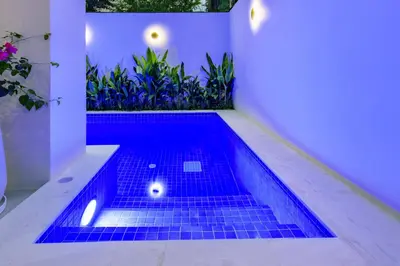 a swimming pool in a house with blue tiles at Palazzo 126 Luxury 5BR Pool Villa in Patong in Patong Beach