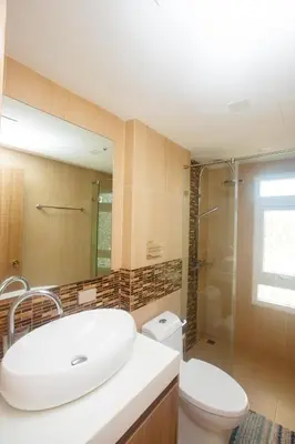 a bathroom with a sink and a toilet and a shower at Calypso Condo Naiharn in Phuket Town