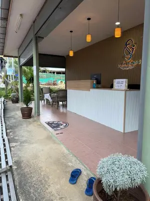 a restaurant with a bar with blue flip flops on a patio at Gypsy Village Resort in Phi Phi Don