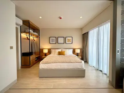 a bedroom with a large bed and two lamps at New apartments in a premium Laguna complex by the lake in Bang Tao Beach