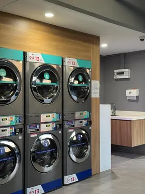 a row of washing machines in a laundry room at New apartments in a premium Laguna complex by the lake in Bang Tao Beach