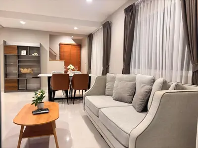 a living room with a couch and a table at Modern 3 BR Villa Pool&Gym only 15min to Bang Tao Beach in Ban Phru Champa