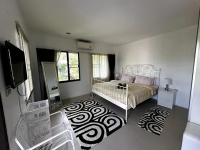 a bedroom with a bed and a television in it at Casa Sakoo pool Villa Naithon in Nai Thon Beach