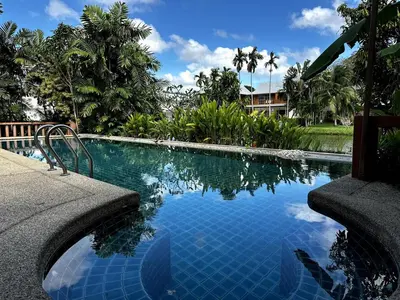 a swimming pool in front of a house at Casa Sakoo pool Villa Naithon in Nai Thon Beach