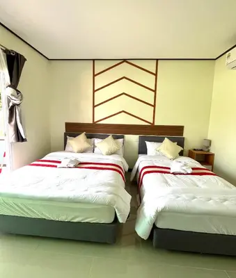 two beds sitting next to each other in a bedroom at 3P Phuket Airport Hotel in Phuket