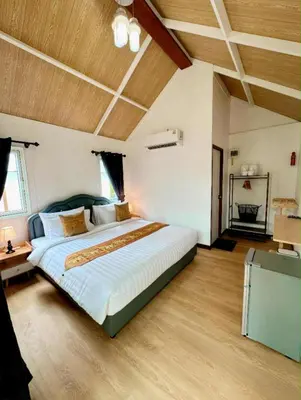 a large bedroom with a large bed and wooden ceilings at The white resort & restaurant koh yao yai in Ban Khlong Hia