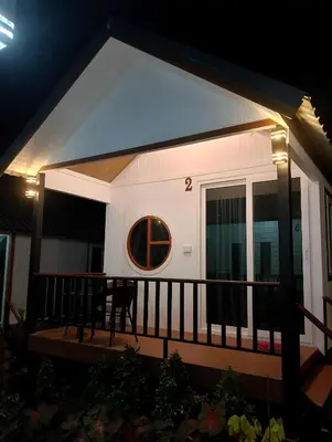 a house with a round window on a balcony at The white resort & restaurant koh yao yai in Ban Khlong Hia