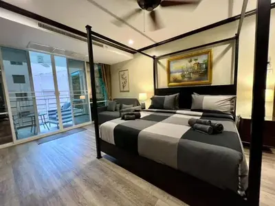 a bedroom with a large bed and a balcony at Karon Beach Seaview Penthouse With Private Pool Condominium in Karon Beach