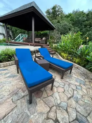 a group of blue benches on a stone patio at Karon Beach Seaview Penthouse With Private Pool Condominium in Karon Beach