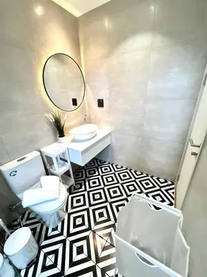 a bathroom with two toilets and a sink and a mirror at Halo 1 , 2 bedroom, 400m to the see in Nai Yang Beach