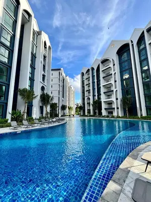 a large swimming pool in front of some buildings at Halo 1 , 2 bedroom, 400m to the see in Nai Yang Beach