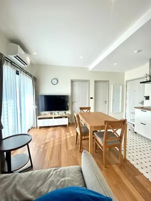 a living room with a table and a couch at Halo 1 , 2 bedroom, 400m to the see in Nai Yang Beach