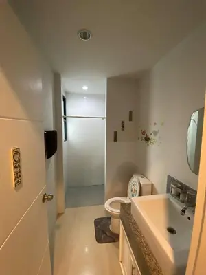 a bathroom with a toilet and a sink and a shower at Town House in Ban Ket Ho