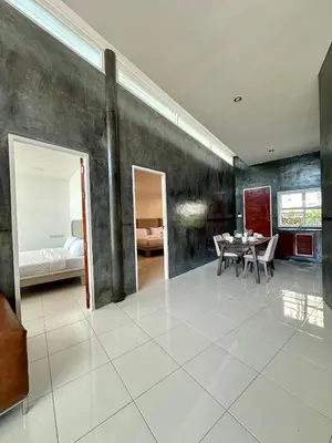 a living room with a table and a bedroom at Amazing Seaview House 2 Bedroom Patong in Patong Beach