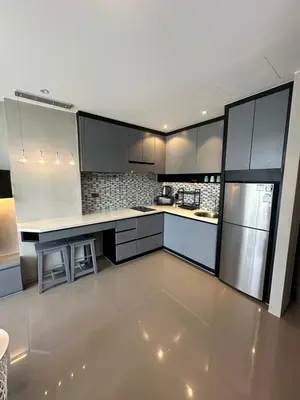 a kitchen with white cabinets and stainless steel appliances at Kamala City Gate 1 bedroom By Ere P710 in Kamala Beach