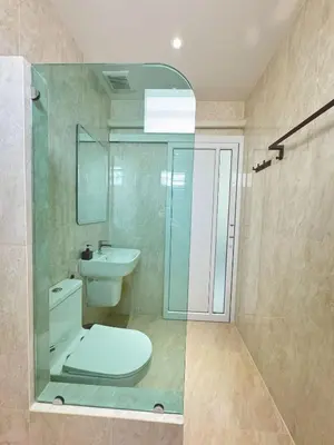 a bathroom with a toilet and a sink and a shower at The Pinda House Bangtao in Bang Tao Beach
