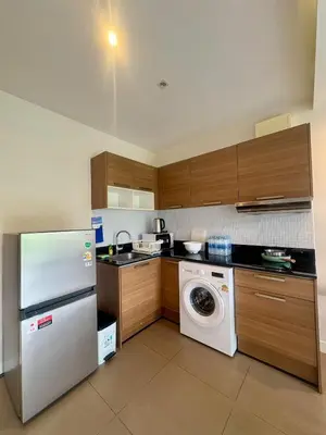 a kitchen with a refrigerator and a washing machine at The Lago Nai Harn 2 BR-Walk to beach by ALL HOMES in Rawai Beach