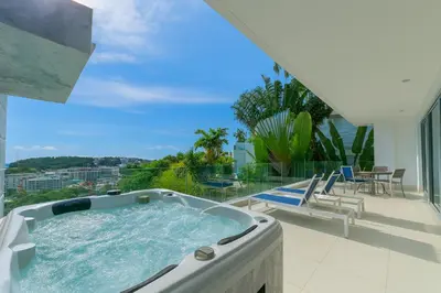a hot tub on the balcony of a house at The View Phuket By RESAVA in Kata Beach
