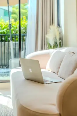 a laptop computer sitting on top of a couch at Zcape 1 By SilqStay in Ban Thalat Choeng Thale