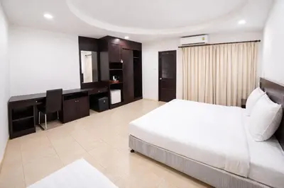 a bedroom with a bed and a desk in it at Hill Side Patong in Patong Beach