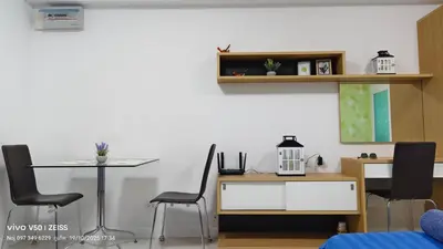 a living room with two chairs and a table and a table and a tableablish at No 498 SPD in Phuket Town