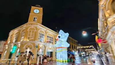 a building with a clock tower on a city street at No 498 SPD in Phuket Town