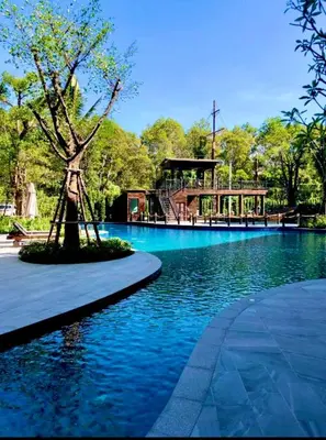 a swimming pool with a tree in the middle of it at naiyang beach in Phuket