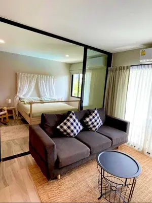 a living room with a couch and a bed at naiyang beach in Phuket