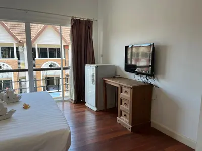 a bedroom with a bed and a television on a dresser at Kata beach at pool house in Kata Beach