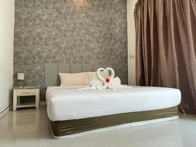 a bedroom with a bed with a stuffed animal on it at Kata beach at pool house in Kata Beach