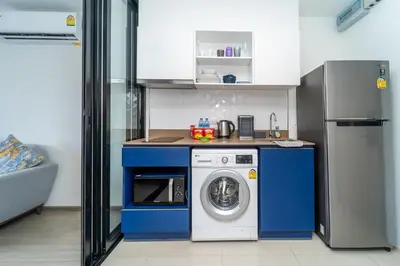 a kitchen with a washing machine and a refrigerator at 1BR Designer Mountain View Condo - Central Phuket in Phuket Town