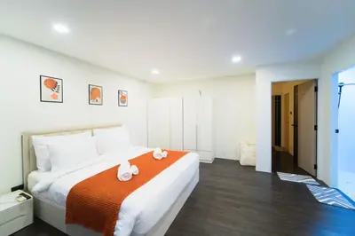 a bedroom with a large bed with two stuffed animals on it at Stylish 3 Bedroom Villa with Garden, Chalong - by PoshSaga in Chalong