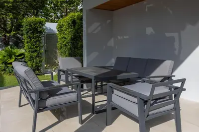 a table and chairs on a patio at Botanica Foresta x MonthStayZ Thailand in Bang Tao Beach