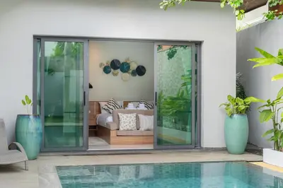a house with a swimming pool and a living room at Nicky Villa Luxury Private Haven in BangTao Laguna in Laguna Phuket