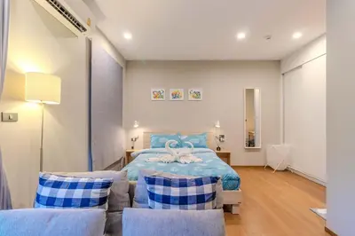 a bedroom with a blue bed and two chairs at C241 2BR Pool Access 5 Min Walk to Rawai Beach in Rawai Beach