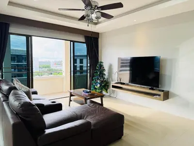 a living room with a couch and a tv and a christmas tree at Patong Elite Condo Nanai, Patong, Phuket in Patong Beach