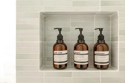 three bottles of soap in a shelf in a bathroom at Nai Harn Beach Holiday Home - Rawai 4bdr in Rawai Beach