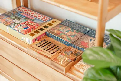 a wooden shelf with toys on top of a table at Nai Harn Beach Holiday Home - Rawai 4bdr in Rawai Beach