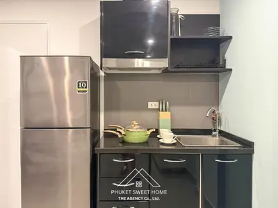 a small kitchen with a refrigerator and a sink at Condo for rent chalong Rawai 610 in Ban Klang