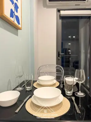 a black table with plates and glasses on it at Condo for rent chalong Rawai 610 in Ban Klang