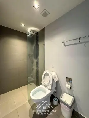 a bathroom with a toilet and a glass shower at Condo for rent chalong rawai 106 in Ban Klang