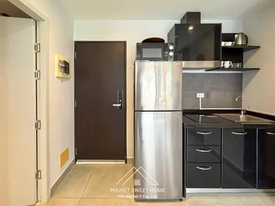 a kitchen with a stainless steel refrigerator and a door at Condo for rent chalong rawai 106 in Ban Klang