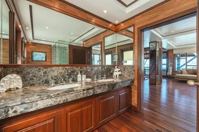 a bathroom with two sinks and a large mirror at 35 - Vast Beach Front Villa in Kamala Beach